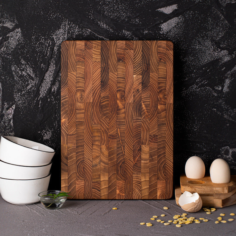 The Walnut Wood Chopping Board stood up, the image is focusing on the wood grain and deep rich wood colors.