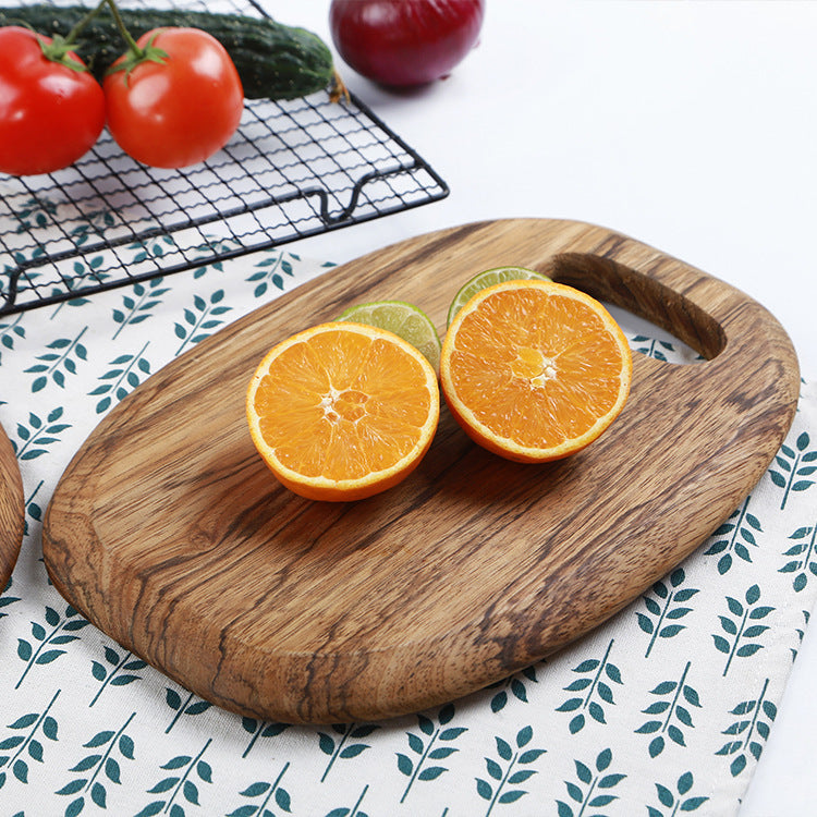 The One-Piece Zebra Wood Cutting Board with a half chopped fruit on it.