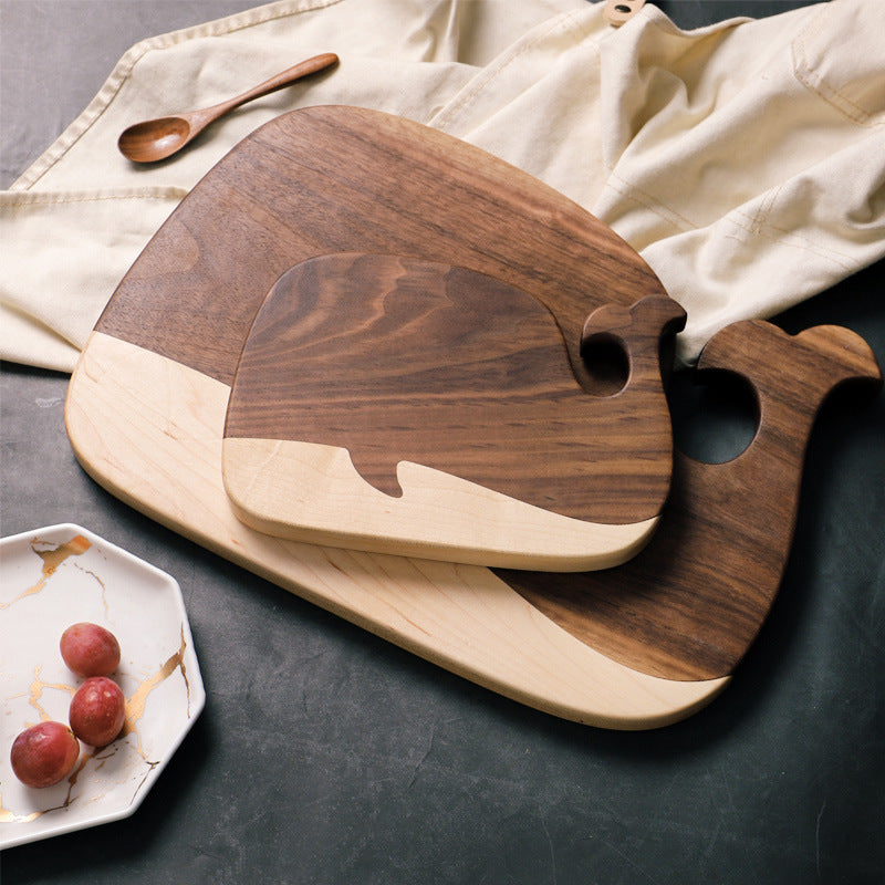 The small and large Black Walnut and Maple Whale Cutting Board stacked on-top of each other.