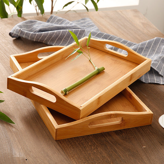 Bamboo Serving Trays stacked on-top of each other, showing their wood grain, and lightweight build.