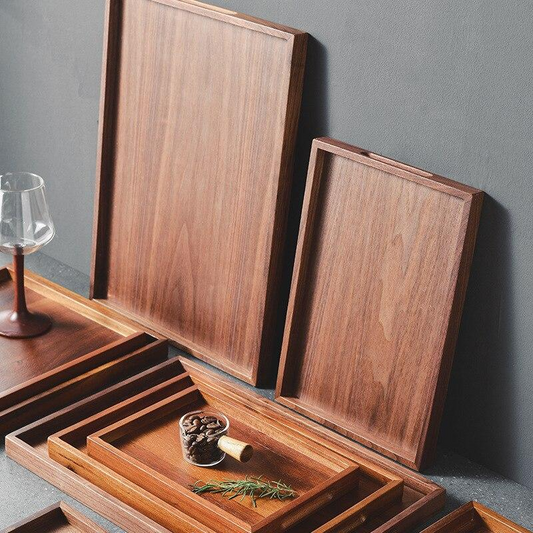 Shows Acacia & Black Walnut Wooden Trays stacked on top of each other showcasing the wood grain.