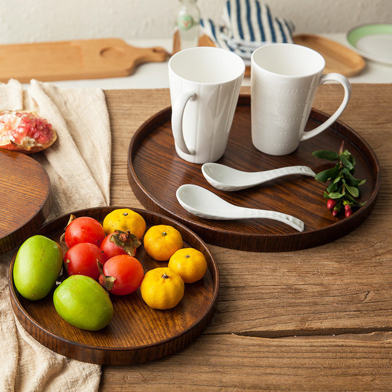 Ash Wood Round Serving Tray holding coffee cups on one tray, and fruits on the other tray.