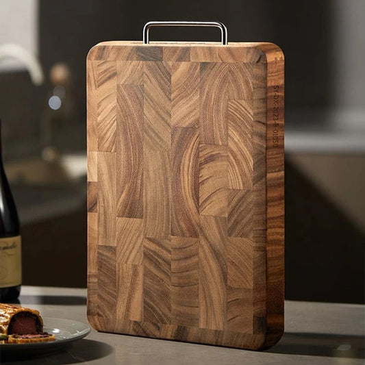 The medium Black Walnut One-Piece Thick Cutting Board standing vertically.
