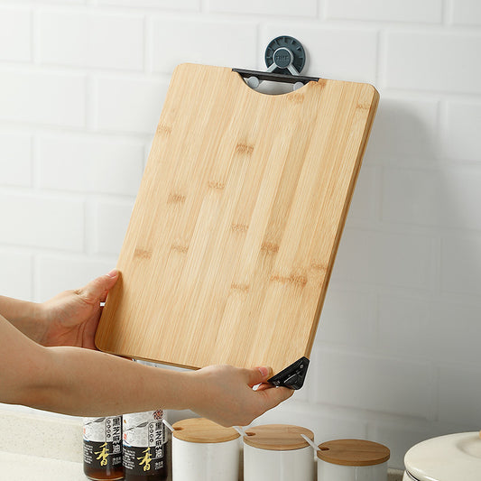 The small Rectangular Bamboo Cutting Board hanging off a wall.