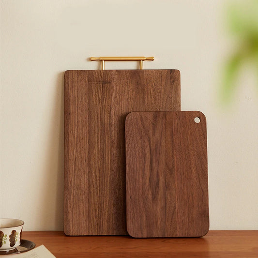 The Solid Black Walnut One-Piece cutting Board standing vertically.