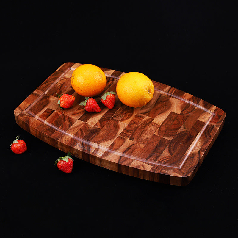 The Wooden Walnut End-Grain Cutting Board with lemons and strawberries on them. Showing a beautiful wood end grain and gorgeous wood color.