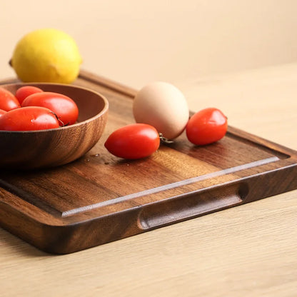 The large Acacia Thick One-Piece Wood Cutting Board showcasing the built in handles.