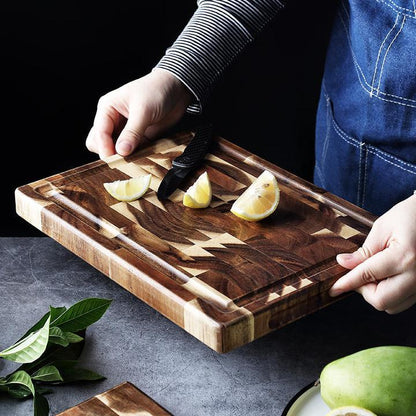 The Parquet Acacia Wood Cutting Board with a half a lemon cut on it. Showing the beautiful wood grain and dark rich wood color.