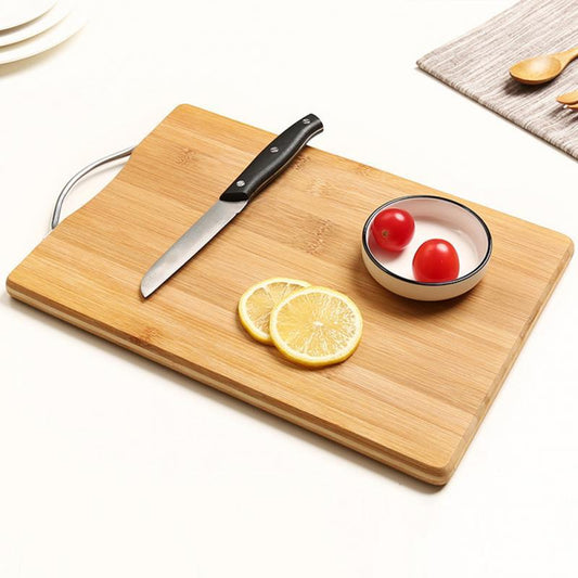 The Simple Bamboo Cutting Board with lemons and tomatoes on it.