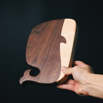 The small Black Walnut and Maple Whale Cutting Board with dark wood grain and beautiful wood color.