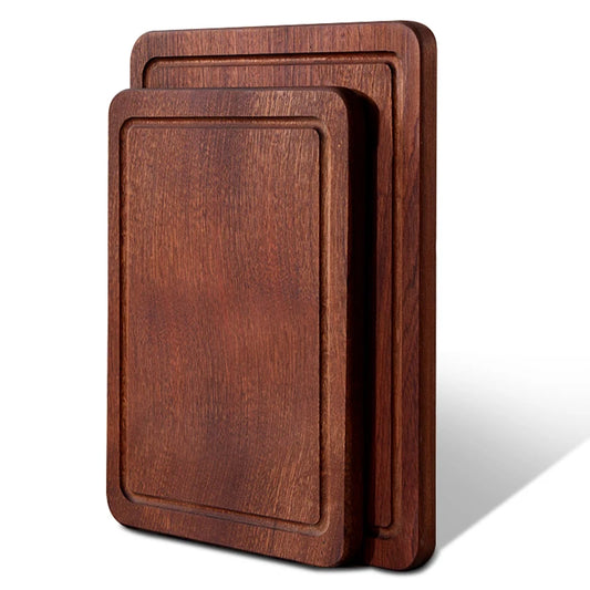 The small and large Solid Ebony Wood Cutting Board standing vertically next to each other.