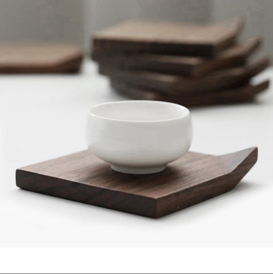 A white mug placed on the Black Walnut Corrugated Coasters, showing a beautiful color contrast from the wood coaster.
