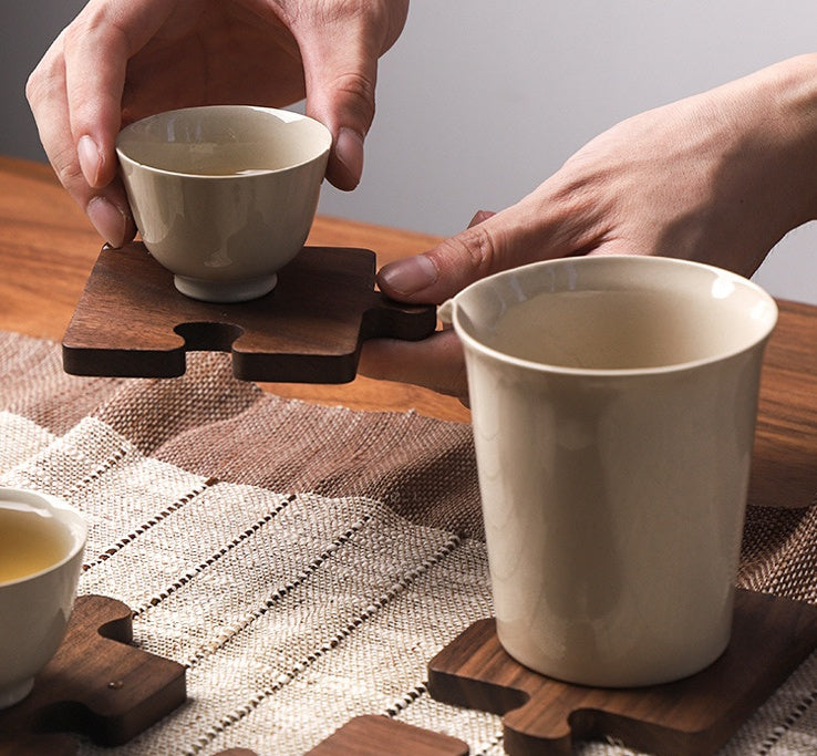 Black Walnut Puzzle Wood Coaster holding the white tea cup.